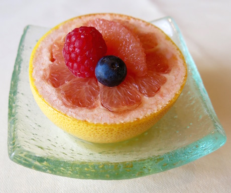 pink grapefruit cut into segments with berries