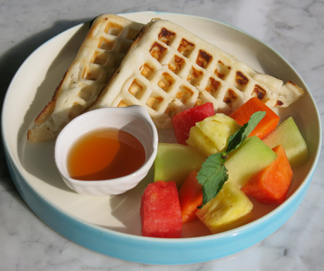 Vegan waffles with fruit salad and palm sugar syrup