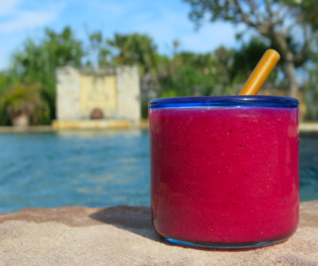 Vibrant and colourful dragon fruit juice next to the swimming pool